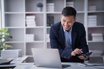 Portrait of Smiling young male employee feel euphoric sitting at his desk using smart the laptop at office.