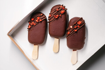 ice lolly with chocolate decorated with fruits side view
