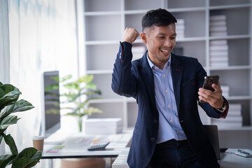 Portrait of Smiling young male employee feel euphoric with promotion offer in paperwork letter in...