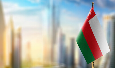 Small flags of the Oman on an abstract blurry background
