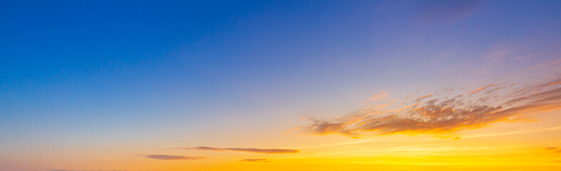 clouds and orange sky,Real majestic sunrise sunset sky background with gentle colorful clouds without birds.Panorama, large