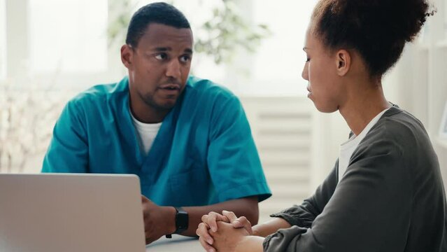 Experienced physician explaining treatment regimen to African American woman