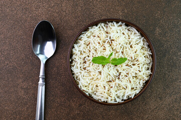 Serving jeera rice also known as cumin rice in a bowl.