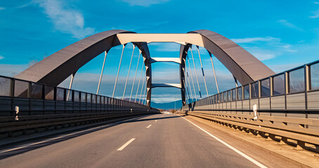 Obraz premium Winter view on a sunny day with a bridge at Plattling, Isar, Bavaria, Germany