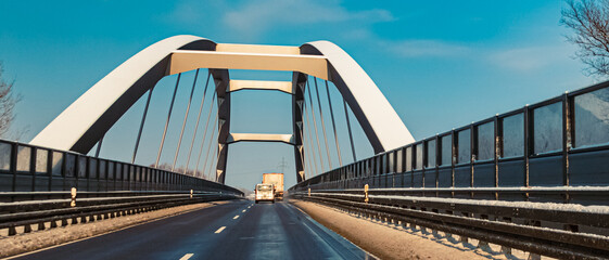 Naklejka premium Winter view on a sunny day with a bridge at Plattling, Isar, Bavaria, Germany
