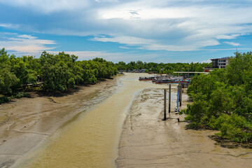 Rivers of ferry terminals and fisherman's piers at estuary during low tide in Thailand.
