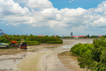 Rivers of ferry terminals and fisherman's piers at estuary during low tide in Thailand.