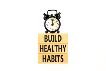 Motivation and Build healthy habits symbol. Concept words Build healthy habits on wooden block on a beautiful white table white background. Business build healthy habits concept. Copy space.