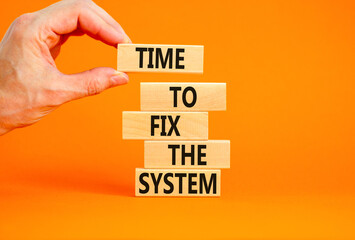 Time to fix the system symbol. Concept words Time to fix the system on wooden block. Beautiful orange table orange background. Businessman hand. Business and time to fix the system concept. Copy space