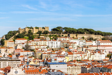 Fototapeta na wymiar View from Miradouro de Sao Pedro de Alcantara of the the Baixa district with Castelo Sao Jorge (St Georges Castle) in the distance, Lisbon, Portugal.
