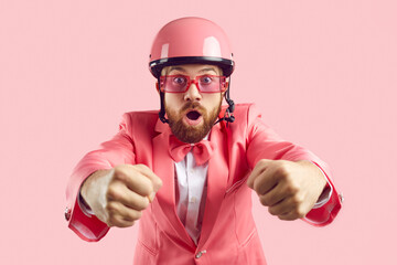 Funny amazed astonished excited open mouthed ginger bearded man in pink helmet, funky suit, bow tie...