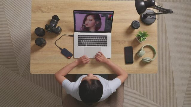 Top View Of Asian Woman Editor Yawning And Sleeping While Sitting In The Workspace Using A Laptop Next To The Camera Editing Photo Of A Woman At Home
