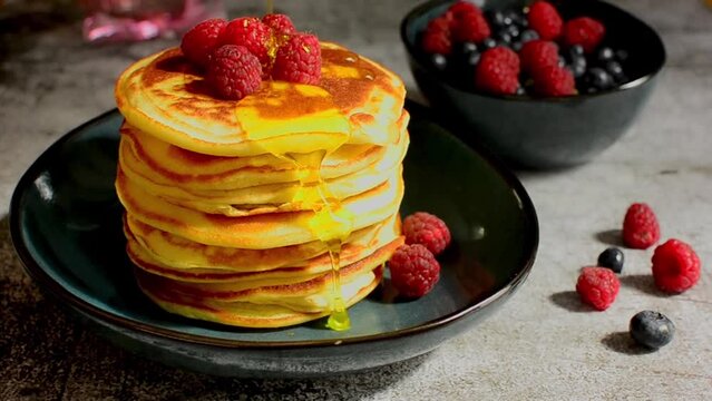 Delicious pancakes close up with fresh berries and honey