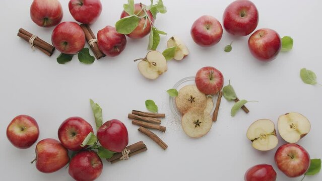 Red apples, one sliced in half, fruit isolated on white background, malus domestica, Fruit Exploding White Background , Red Natural apples with slice and leafs, cinnamon, raw food on studio shot