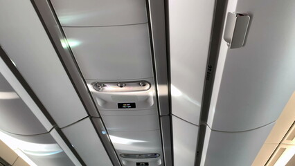 Airplane ceiling, close-up of plane detail overhead luggage