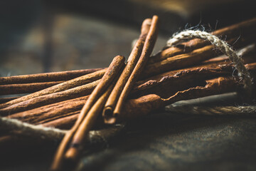 Cinnamon sticks on rustic dark background, selective focus