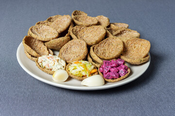 Rye bread toasts on a plate on a tablecloth