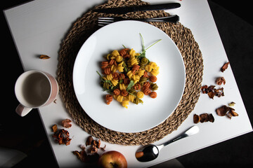 pasta on a white plate on a dark background.