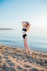 Fototapeta premium a woman in a swimsuit on the sea on the shore rest walking journey