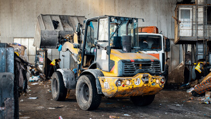 An excavator working at waste sorting plant