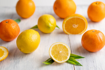 Blurred image of lemons and oranges on a light table. Fruit background.