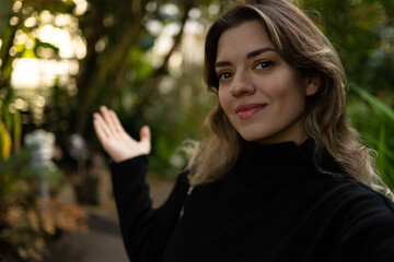 Naklejka premium Young woman is taking selfie with trees.