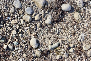 The rock and pebble gravel ground surface.