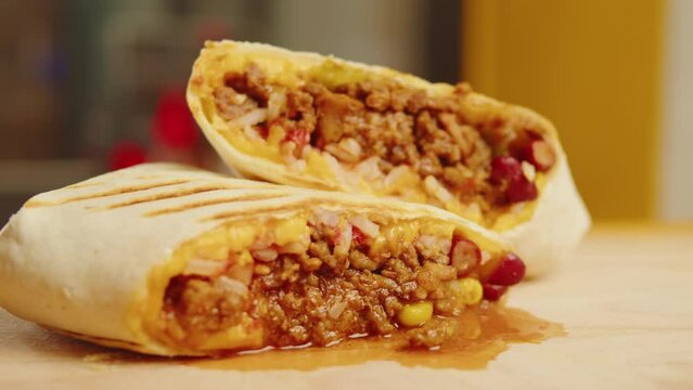 Close up of chef cooking burrito, Eating Traditional Mexican food, tex mex cuisine. Hands taking cooked quesadilla with vegan pork beef meat and vegetables. Shawarma or doner kebab cafe.
