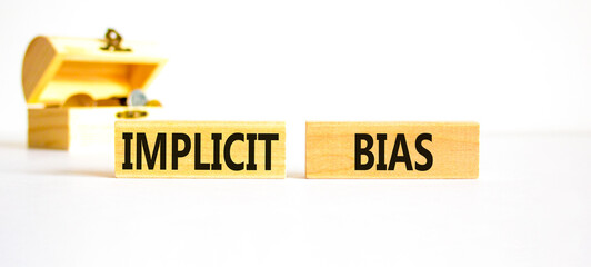 Implicit bias symbol. Concept words Implicit bias on wooden block. Beautiful white table white...