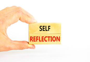 Self reflection symbol. Concept word Self reflection typed on wooden blocks. Beautiful white table white background. Businessman hand. Business psychological and self reflection concept. Copy space.