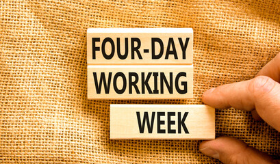Four-day working week symbol. Concept words Four-day working week on wooden block on a beautiful...