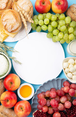 Jewish Shavuot Holiday Card. Dairy Products, Grapes, Cheese, Bread, Milk on Blue Background.