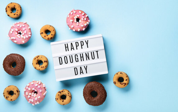 Donuts Doughnuts with Chocolate, Pink Marshmallow and Sugar Sprinkles on Blue Background - Powered by Adobe