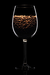 Coffee beans in wine glass isolated on black background