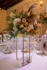 Luxury wedding table setting with flower centerpieces and candles