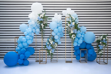 decor with balloons of white, blue and flower arrangemets. Party decorations. Blue and white.