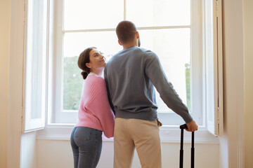 Rear View Shot Of Tourists Spouses Standing In Hotel Suite