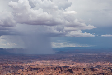 Fototapeta na wymiar Dark clouds accumulating to rain storm over Split Mountain Canyon seen from Grand View Point Overlook near Moab, Island in the Sky District, Canyonlands National Park, San Juan County, Utah, USA