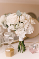 The bride's bouquet and the beautiful details of the bride's morning