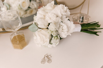 The bride's bouquet and the beautiful details of the bride's morning