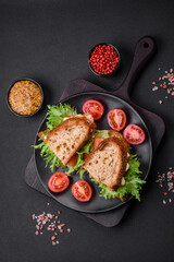 Delicious caprese sandwich with grilled toast, mozzarella, lettuce and tomatoes