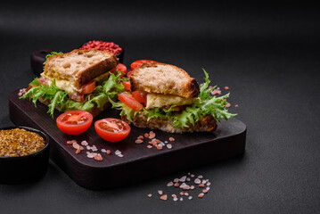 Delicious caprese sandwich with grilled toast, mozzarella, lettuce and tomatoes