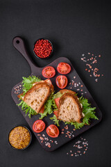 Delicious caprese sandwich with grilled toast, mozzarella, lettuce and tomatoes