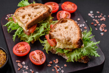 Delicious caprese sandwich with grilled toast, mozzarella, lettuce and tomatoes