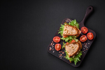 Delicious caprese sandwich with grilled toast, mozzarella, lettuce and tomatoes