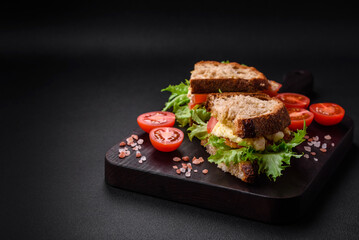 Delicious caprese sandwich with grilled toast, mozzarella, lettuce and tomatoes