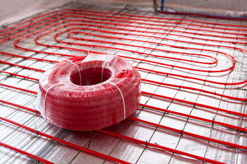 Laid red pipes made of cross-linked polyethylene PEX for underfloor heating