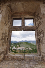 The Tirino valley seen through an opening in a window of the Piccolomini Castle in Capestrano (AQ)