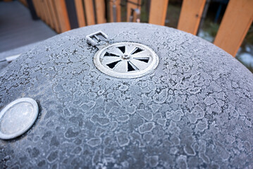 A close up of a bbq grill covered in ice