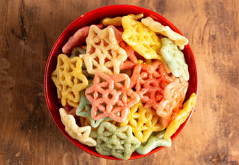 Serving of Cooked Star Shaped Fryums on a Wooden Table